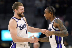 Dec 6, 2024; San Antonio, Texas, USA; Sacramento Kings center Domantas Sabonis (11) and forward DeMar DeRozan (10) embrace before a game the San Antonio Spurs at Frost Bank Center. Mandatory Credit: Scott Wachter-Imagn Images