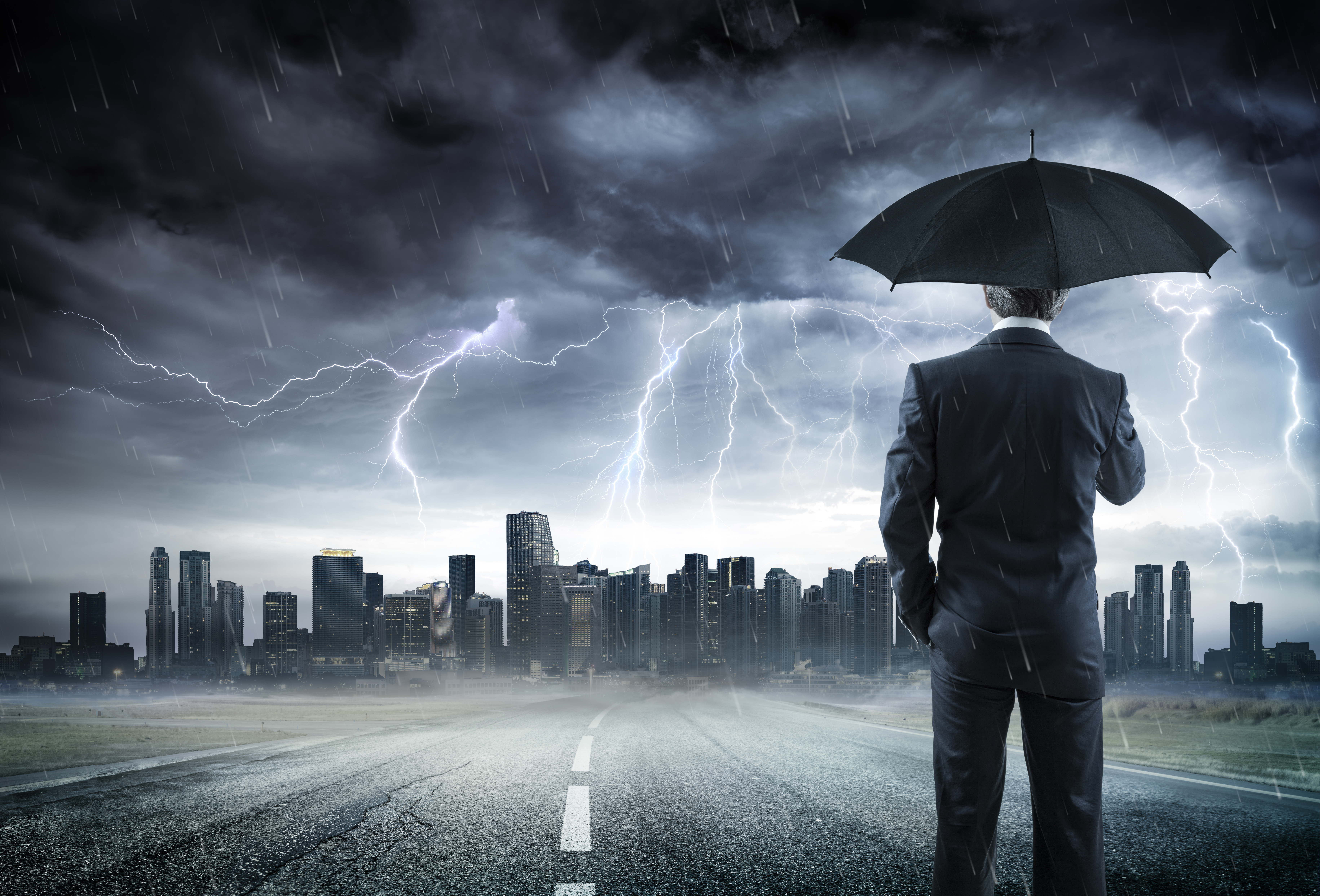 Business man With Umbrella Looking Storm Over City