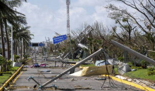 Downed electrical poles and lines blown over by Hurricane Otis blanket a road in Acapulco, Mexico, Friday, Oct. 27, 2023. (AP Photo/Felix Marquez)